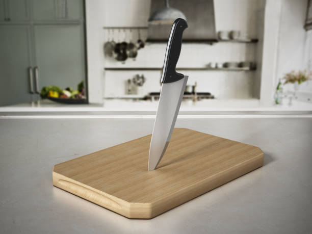 couteau de cuisine sur la coupe de bois debout sur le comptoir de cuisine - table knife photos et images de collection