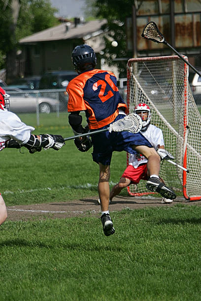 istock Dynamic Male Lacrosse Player Fires Ball at Goal 89962361
