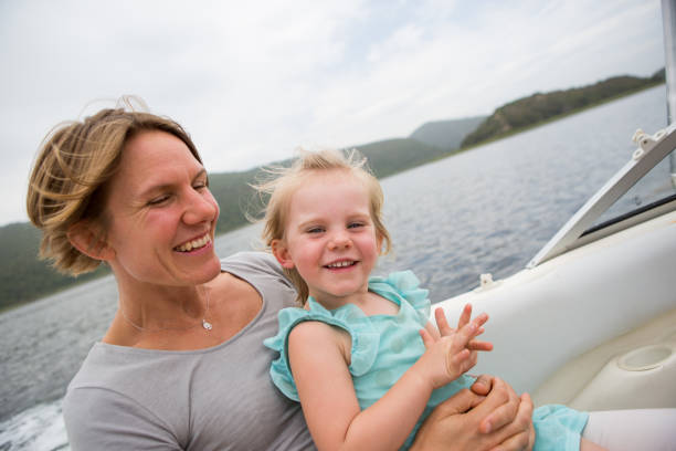 istock Mother and daughter enjoying a boat ride 899623918