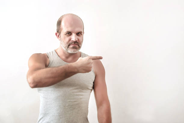istock Man strong constitution indicates the index finger direction to the right 899627670