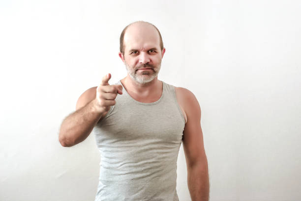 istock strong physique man points finger directly at the viewer 899627874