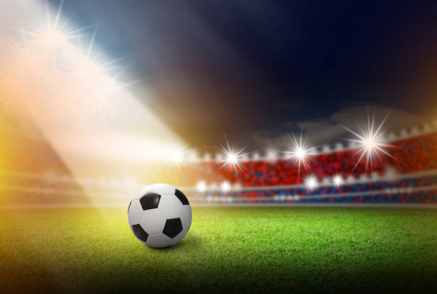 istock Football on soccer stadium with light 899627910
