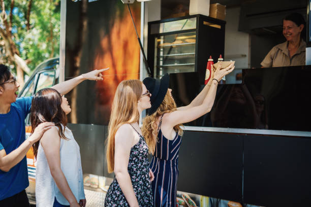 istock Ordering food and drinks from food truck 899627974