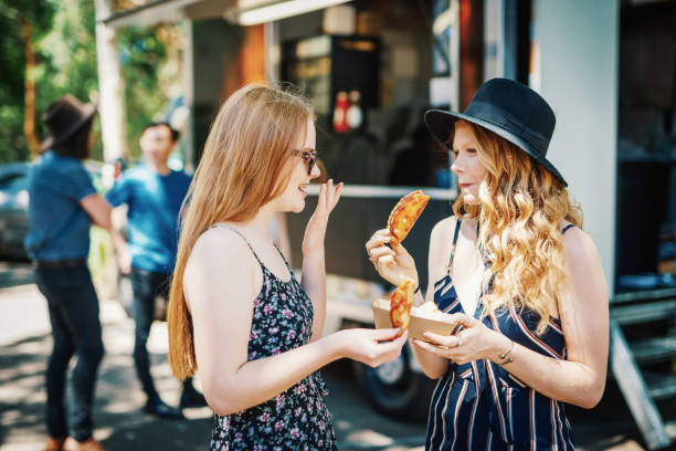 istock Going for a tasty snack from food van with friends 899628116