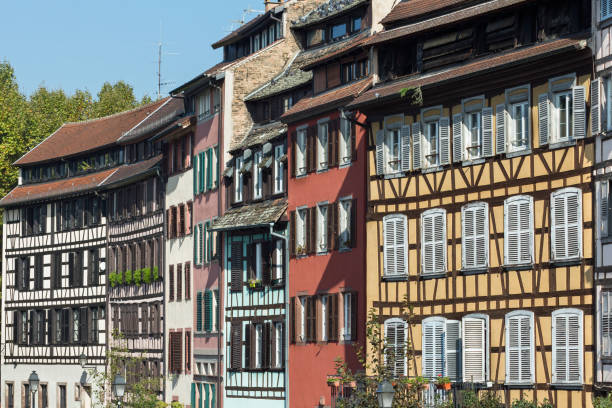 Strasbourg: Beautiful half-timbered houses in the Quarter La Petite France The Old Town of the french city Strasbourg, ( Bas-Rhin, Alsace, France ). Quarter La Petite France - a local landmark and UNESCO World Heritage. Travel destination and very popular with tourists. View onto ancient half-timbered medieval houses with colorful facades. petite france strasbourg stock pictures, royalty-free photos & images