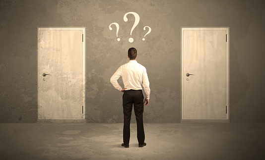 Salesman standing in front of two doors, unable to make the right decision concept with question marks above his head