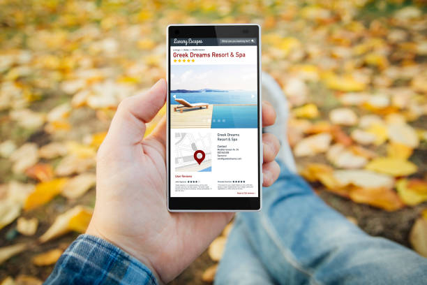 istock man in the park browsing resort spa website 899629650