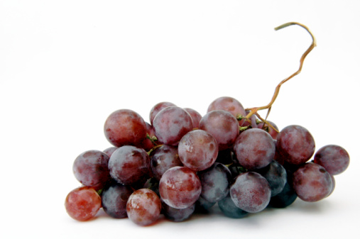 Bunch of red grapes on white background.