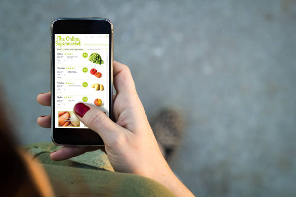 istock Woman walking smartphone online supermarket interface 899629846