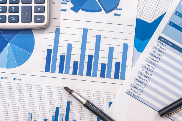 istock Financial development - calculator and pen on chart and graph paper. 899632086