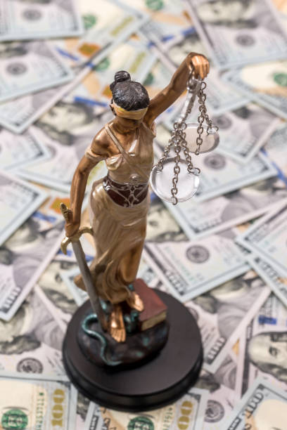 istock Themis statue standing against the background of dollars 899632424