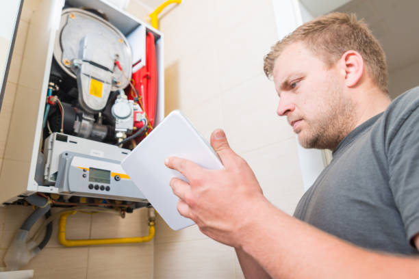 기술자 수리 가스 용광로 사용하여 디지털 태블릿 - heating engineer 뉴스 사진 이미지