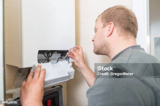 Technician Repairing Gas Furnace Stock Photo - Download Image Now - Furnace, Installing, Radiator - Heater