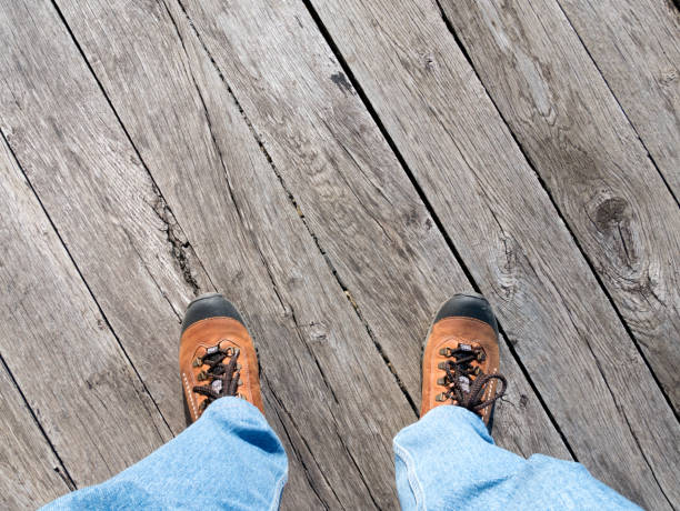 istock Feet on the old wooden bridge. 899632696