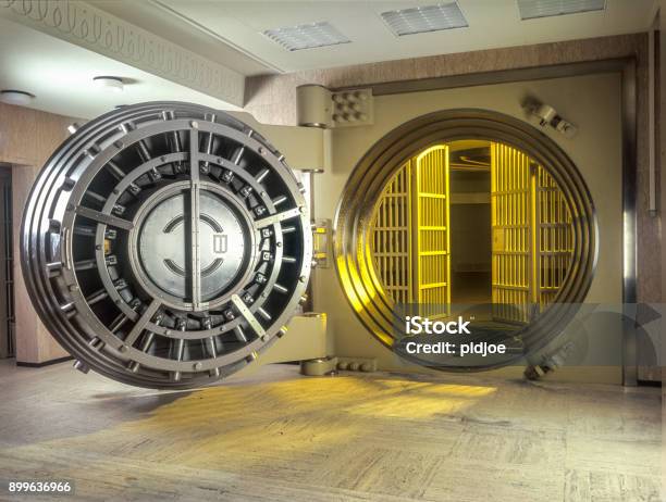 Very Large Open Safe With Golden Light Shining From Within The Safe Stock Photo - Download Image Now