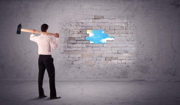 istock Business man hitting brick wall with hammer 899637026