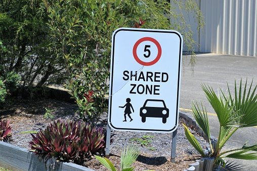 Street sign 5 speed limit and shared zone.