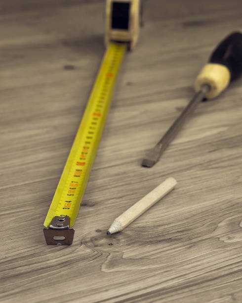 istock Focus on measure tape, pencil and screwdriver 899637208