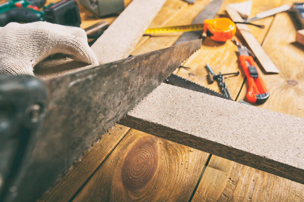 istock Man is sawing a wooden plank 899641436