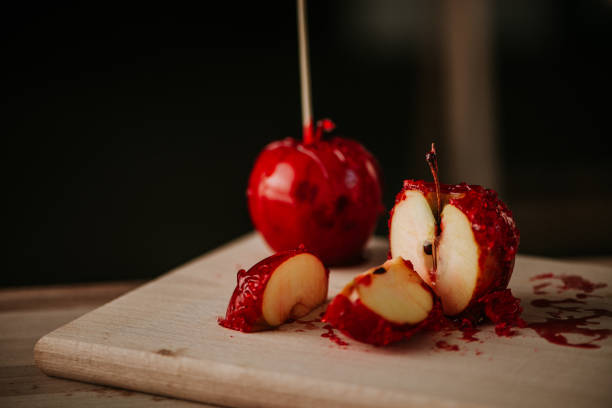 istock Sliced candy apples on wooden board. 899649436