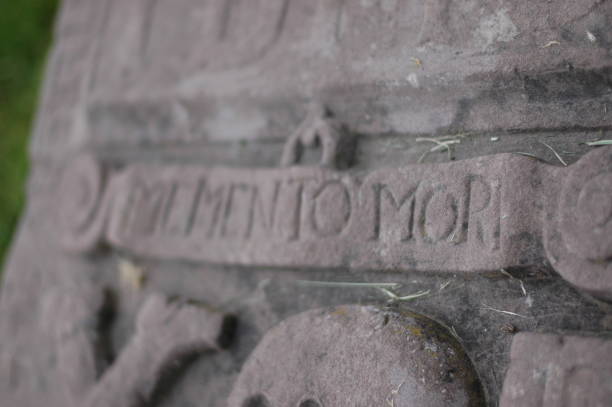 istock 'Remember you must die' on an ancient gravestone 899649518