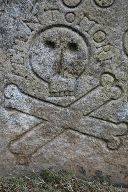 Detail from an 18th century headstone in a cemetery in Concord, Massachusetts.  The winged death's head design was common in 18th century New England.  \