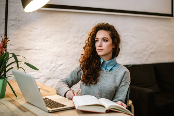 istock Thoughtful woman with book in her hand. 899650066