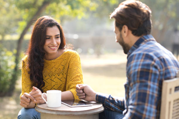 istock Romantic Indian couple having coffee at park 899658180