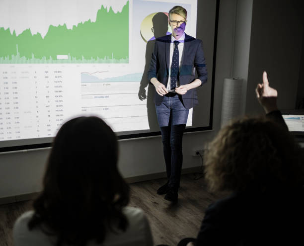 istock Business conference with projection screen audience asking question 899658382