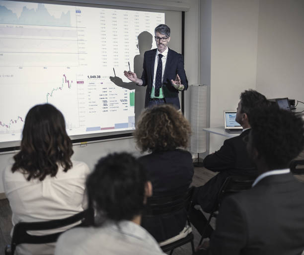 istock Businessman doing a business presentation in front of audience 899658394