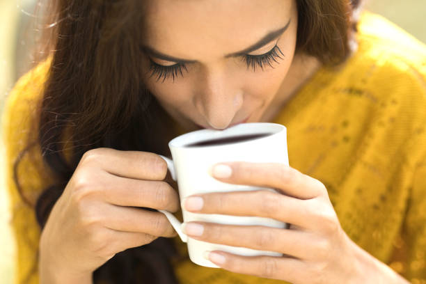 Woman drinking coffee Close-up of beautiful Indian woman drinking coffee black coffee stock pictures, royalty-free photos & images