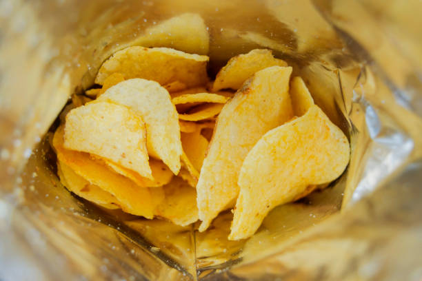 Potato chips in an open bag Potato chips in an open bag ready to eat stock pictures, royalty-free photos & images