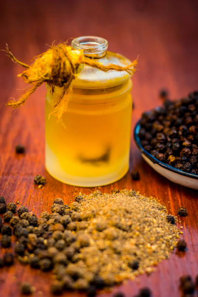 istock Black pepper,Piper nigrum with its powder and oil. 899663054