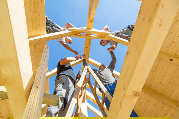 istock Builders at work with wooden roof construction. 899669920