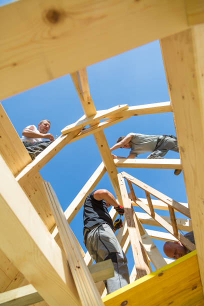 istock Builders at work with wooden roof construction. 899669960