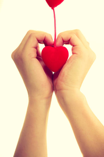 istock Female hands with little hearts. 899671292