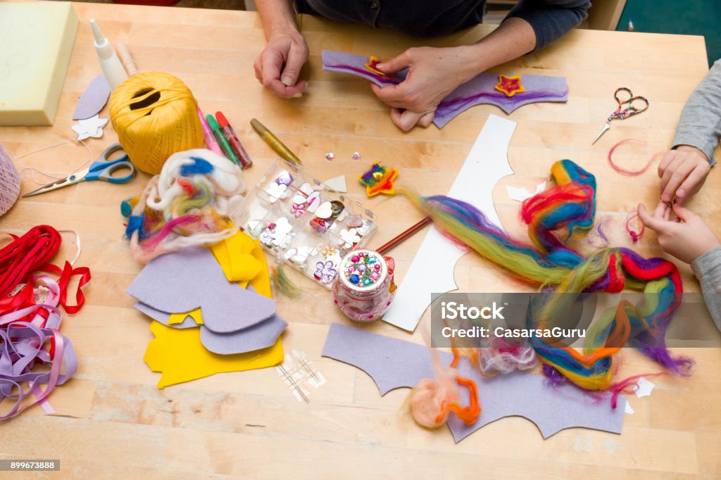 Hands Making Beautiful Princess Crown from Felt Making a beautiful princess crown. Craft Stock Photo