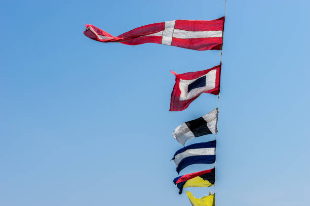 istock Old Navy Flags Signal Symbols with Blue Sky 899674616
