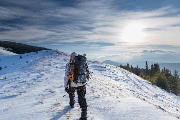 istock Man is backpacking in winter mountains 899675774