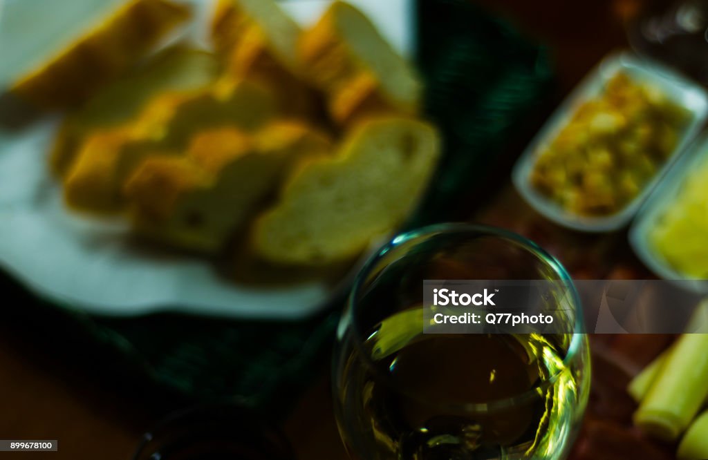 white wine in a glass with appetizers on a wooden table, a set of starters, relax with a glass of wine, white wine in a glass with appetizers on a wooden table, a set of starters, relax with a glass of wine, white wine Alcohol - Drink Stock Photo