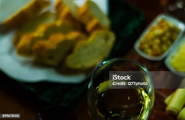 White Wine In A Glass With Appetizers On A Wooden Table A Set Of Starters Relax With A Glass Of Wine Stock Photo - Download Image Now