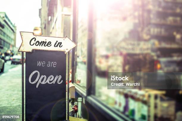 Come In Were Open Sign On A Glass Door Stock Photo - Download Image Now - Open Sign, Business, Sign