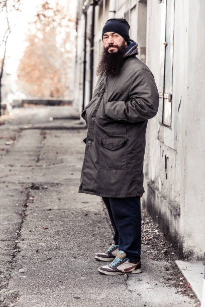 istock Mid Adult Man Begging On Empty Cold Winter Street 899680118