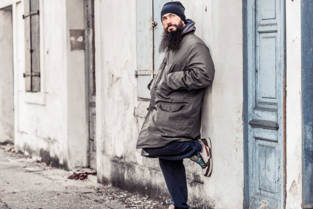 istock Mid Adult Man Begging On Empty Cold Winter Street 899680132