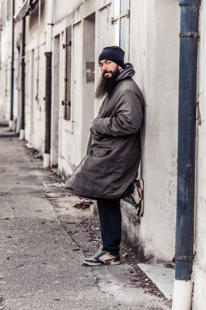 istock Mid Adult Man Begging On Empty Cold Winter Street 899680144