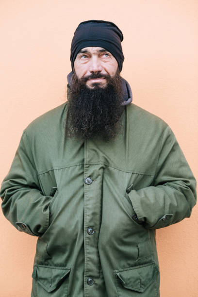 istock Man With Beard In Warming Clothes On Orange Background 899680194