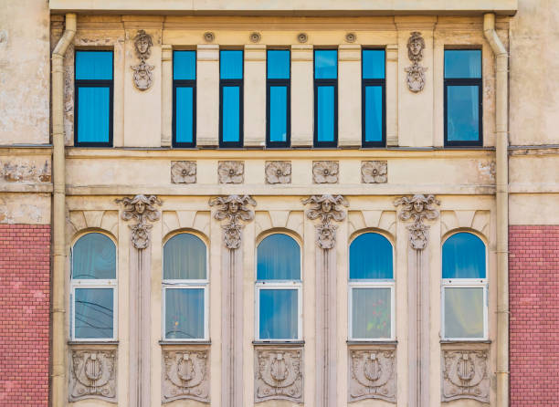 Several windows in a row on the facade of the urban historic building front view, Saint Petersburg, Russia