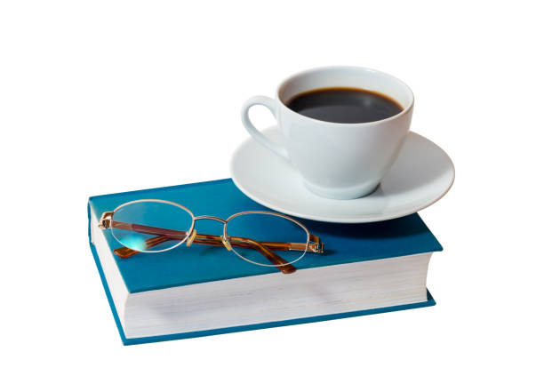 istock White cup of coffee and book with glasses isolated 899682838