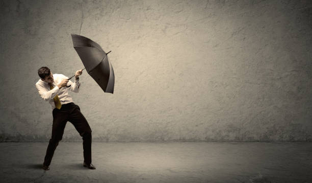 istock Handsome business man holding umbrella with copy space background 899685194