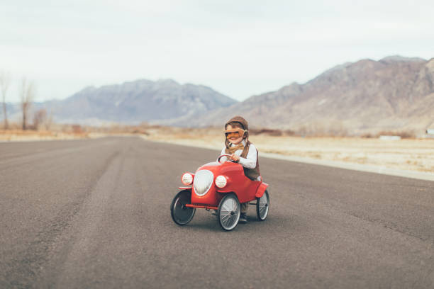 istock Young Vintage Boy Drives Toy Car 899687384